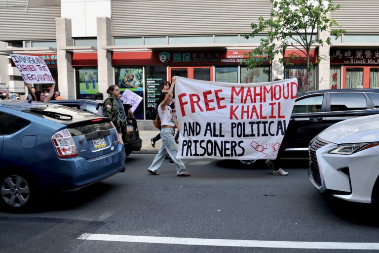 Protesters disrupt traffic on 8th Street during a protest spurred by ICE arrests.
