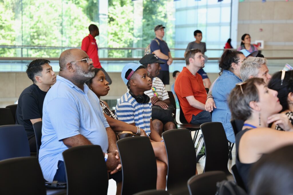 People sitting in the audience listening to the presentation