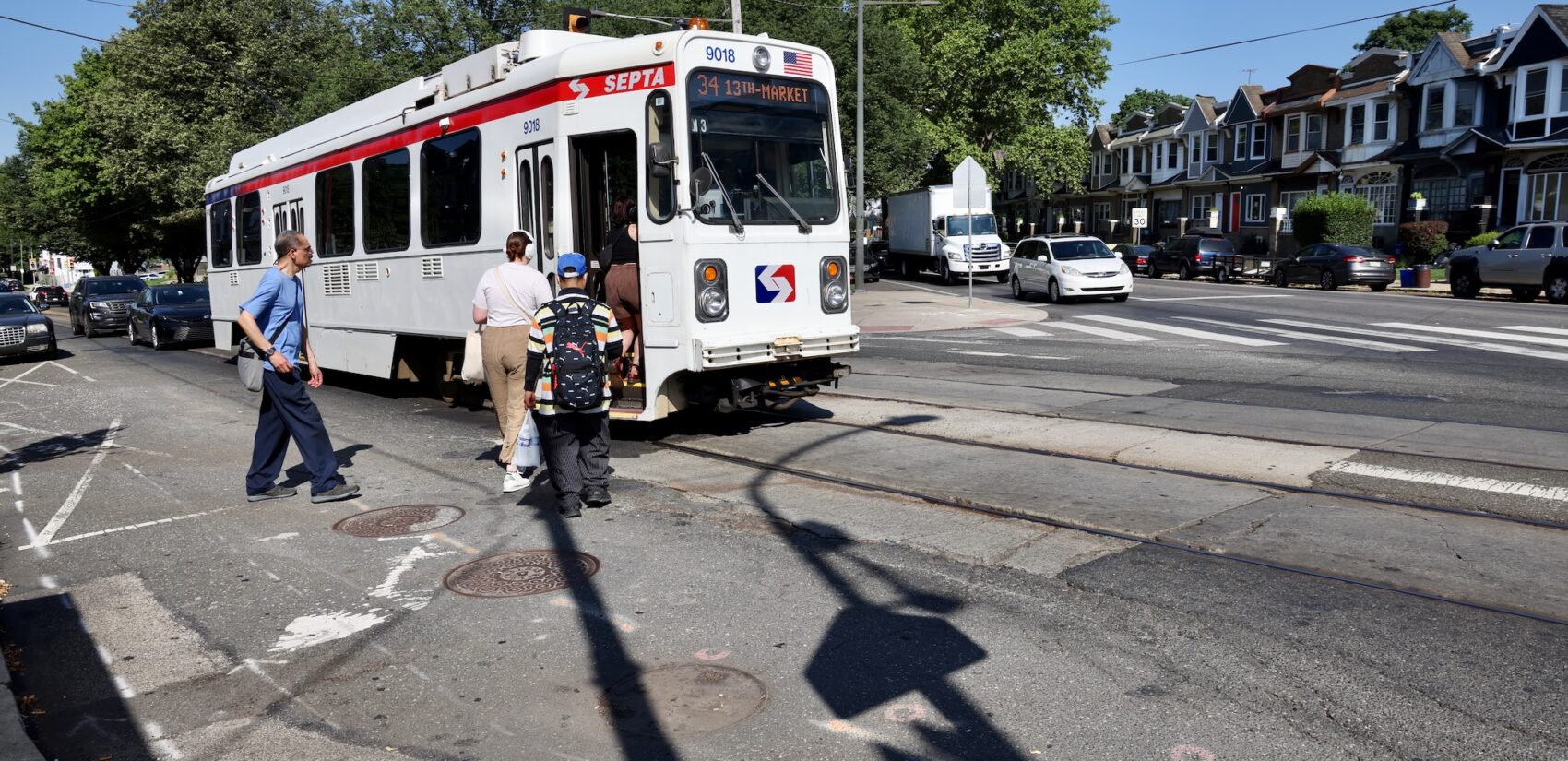 people board a trolley at the intersection of Baltimore Avenue, Cobbs Creek Parkway and 58th Street