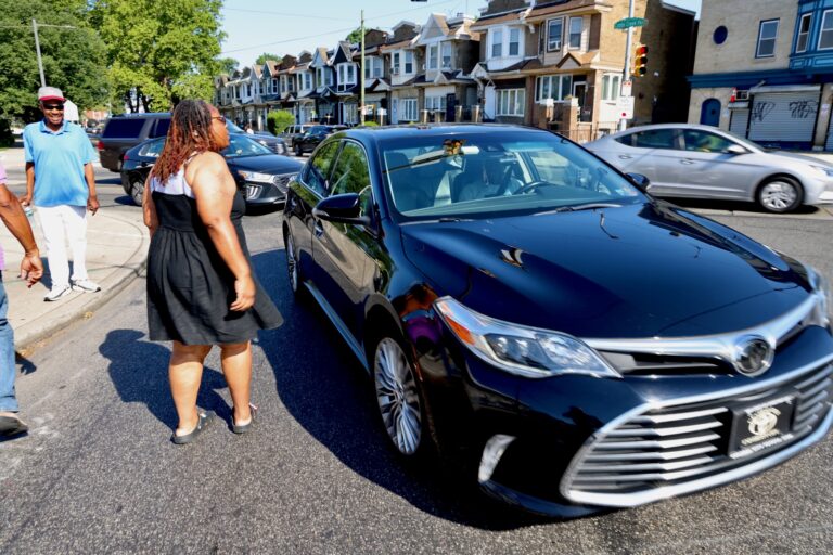 Yasmeen Williams speaks to a driver at the intersection of Baltimore Avenue, Cobbs Creek Parkway and 58th Street