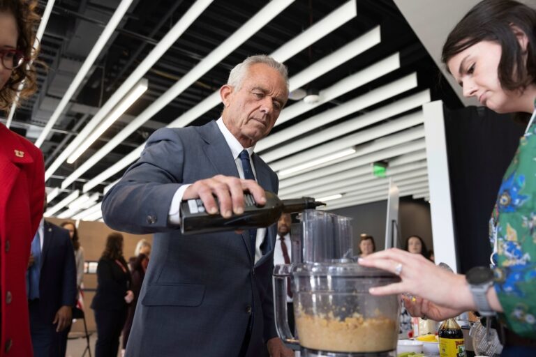 U.S. Health Secretary Robert F. Kennedy Jr. assists in a demonstration as he visits the Osher Center for Integrative Health at the University of Utah, Monday, April 7, 2025, in Salt Lake City. (AP Photo/Melissa Majchrzak)