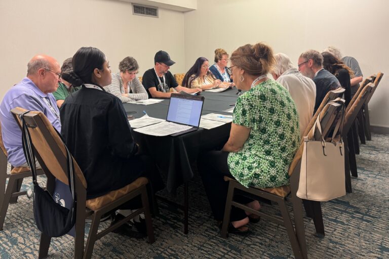 participants at America in One Room discuss at a table