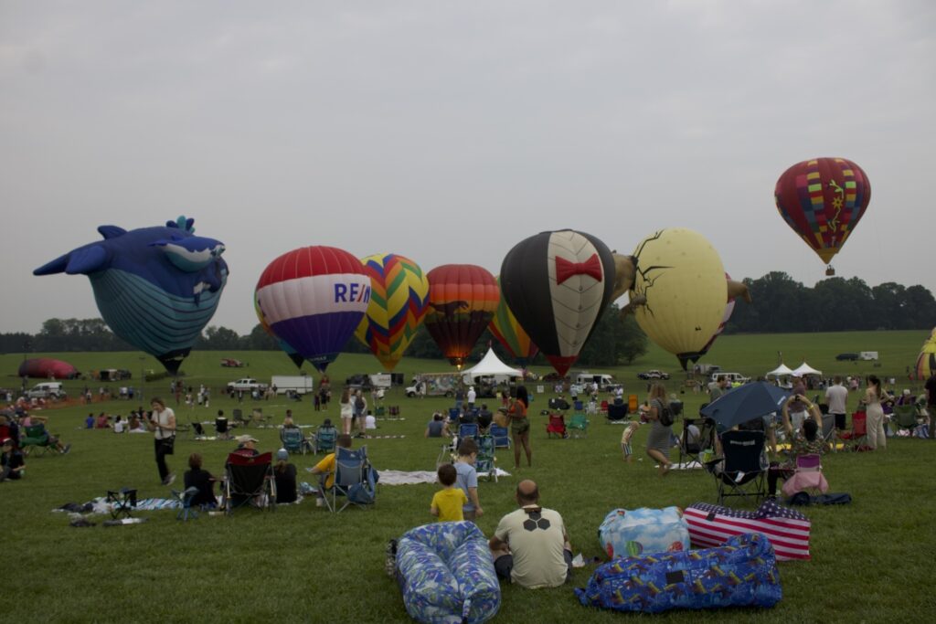 HAB LAWN Several hot air balloons sit on the ground at the Chester County Balloon Festival. (Davis Cuffe/WHYY)