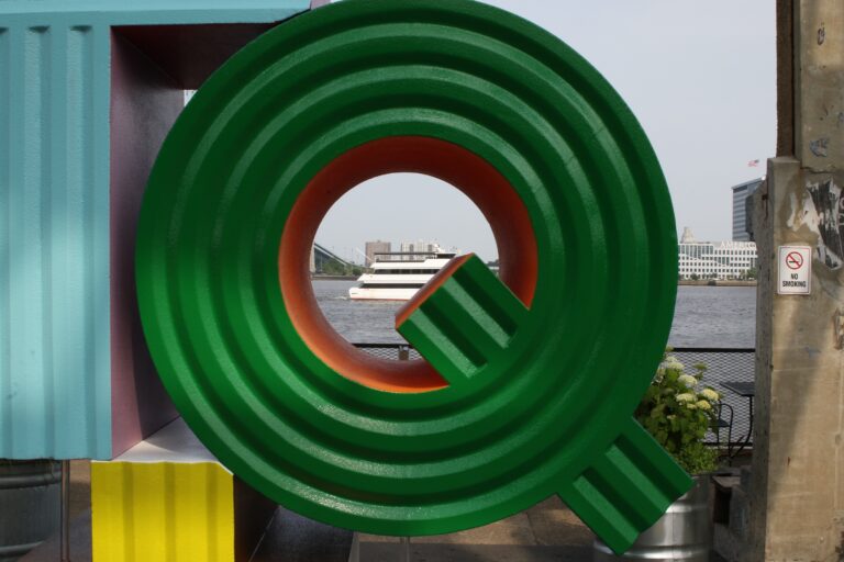 close-up on the Q of the In Plain Sight sculpture at Cherry Street Pier
