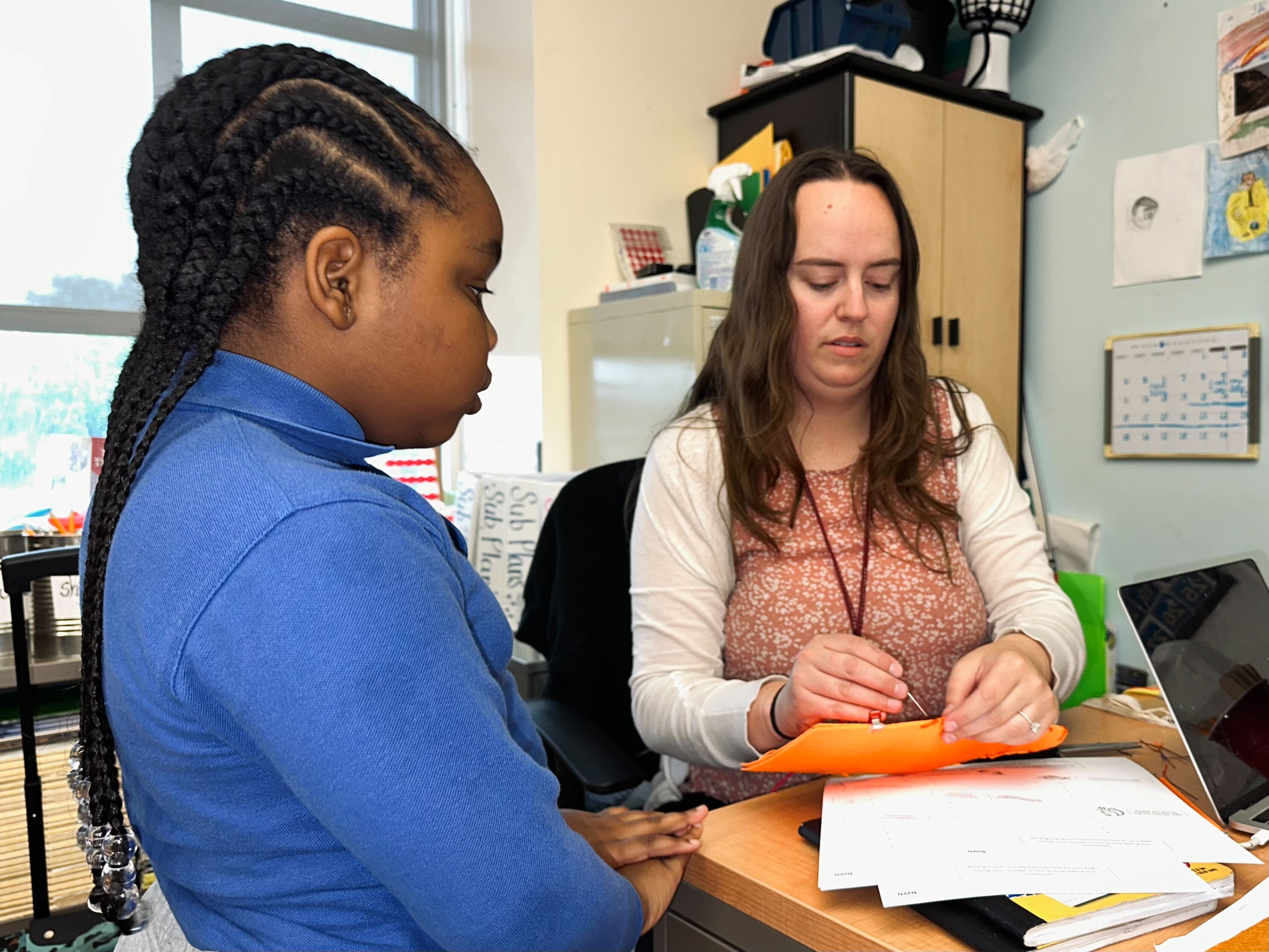 Emma Salisbury helps a student with a puppet
