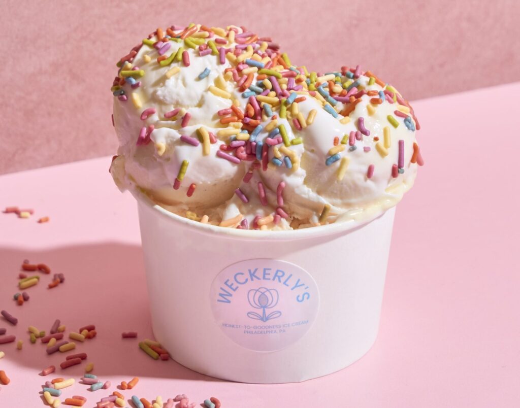 Weckerlys-Scoop-Sprinkles-scaled-e1749065428377 Cup of ice cream with rainbow sprinkles