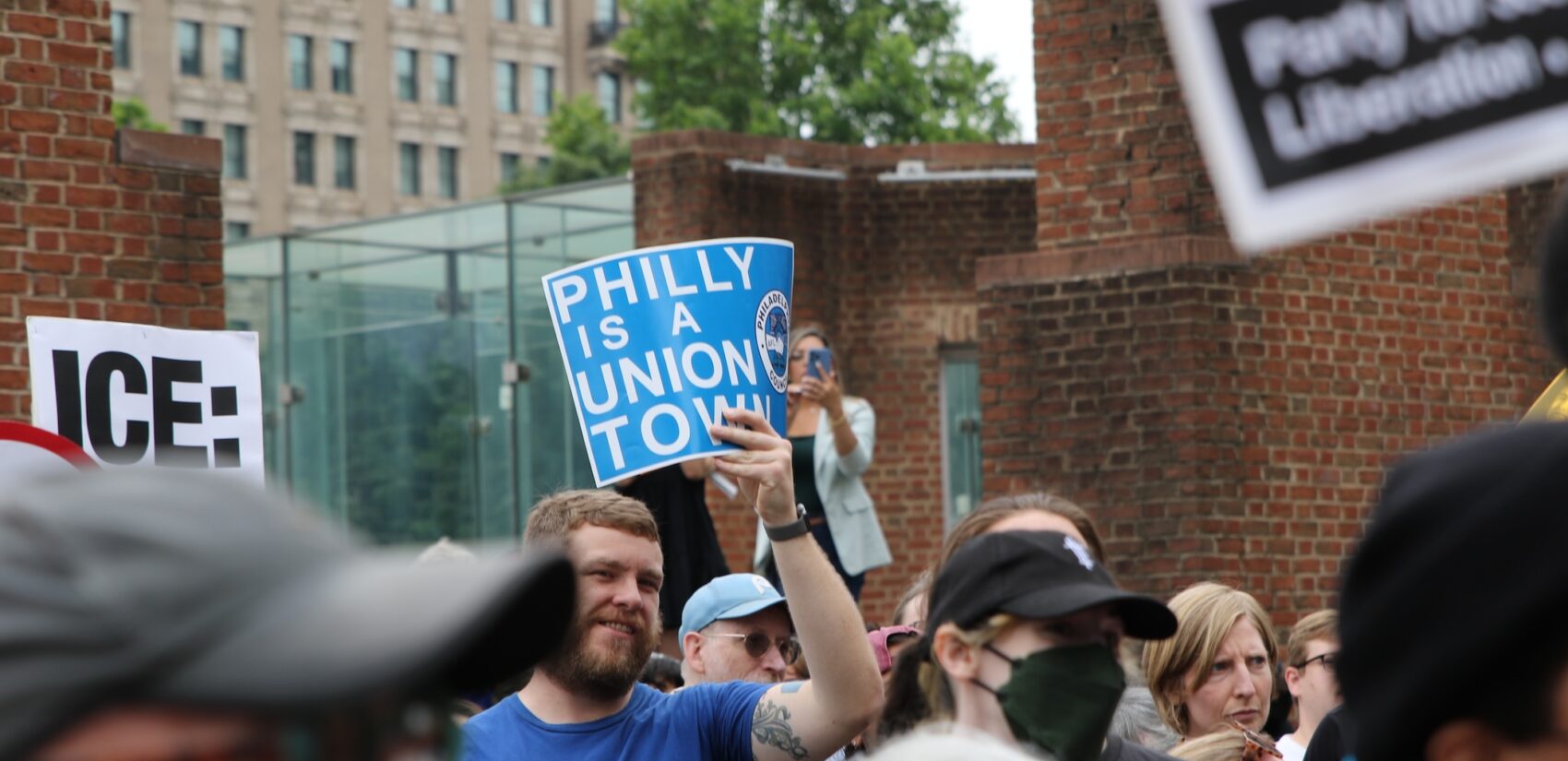 People holding up signs as they gather at the protest