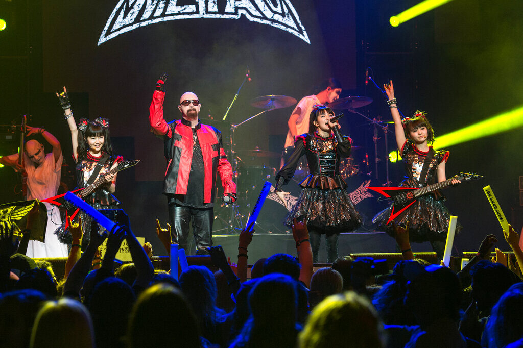 Yui Mizuno, Suzuka Nakamoto, Moa Kikuchi, and Rob Halford Members of the band BABYMETAL perform on stage
