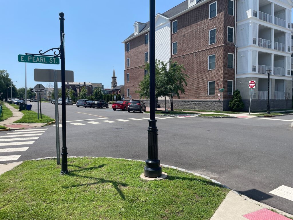 Conflicting signage is at a corner of Pearl Pointe Luxury Apartments