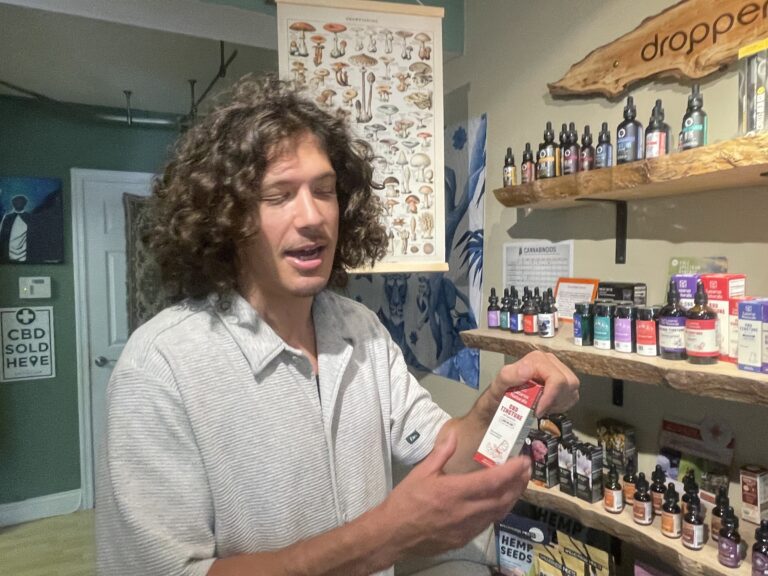 Jesse Ginefra holding up a product in the store