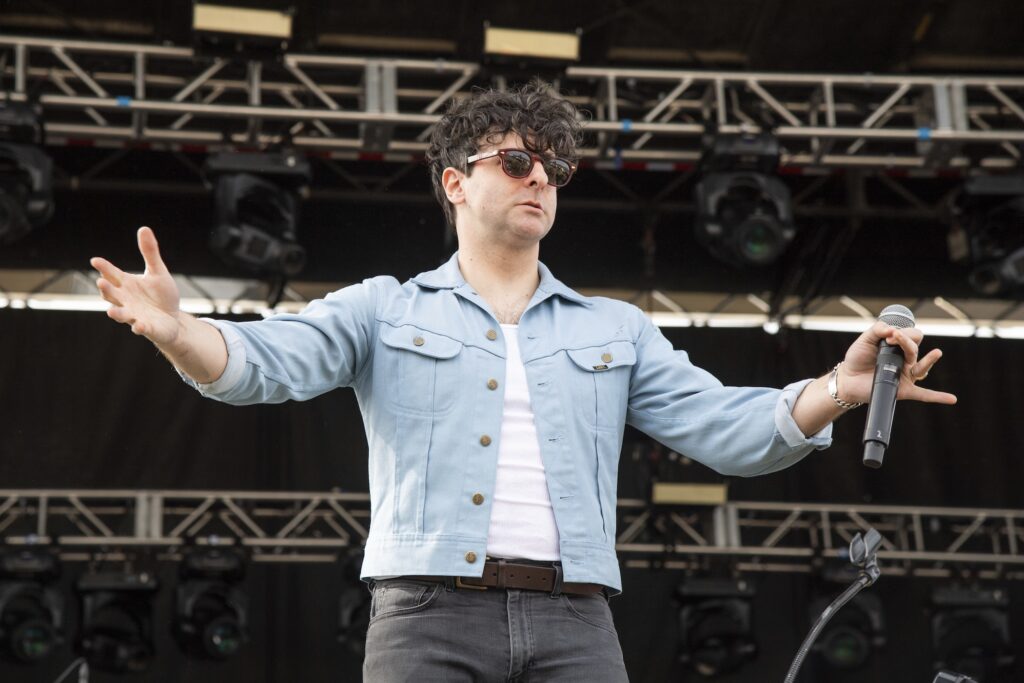 Low Cut Connie Adam Weiner on stage holding his hands up to the crowd