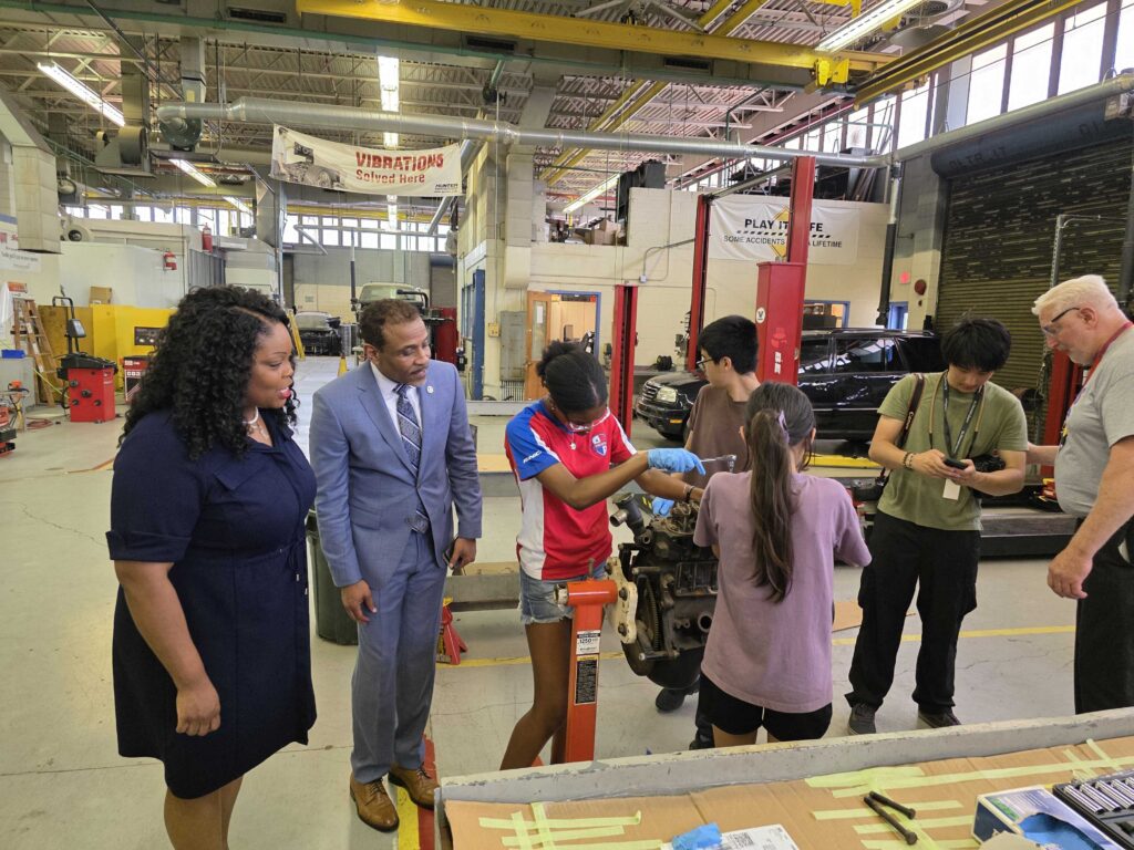 Students work on an automobile engine