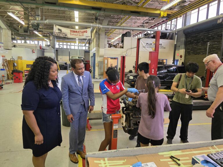 Students work on an automobile engine
