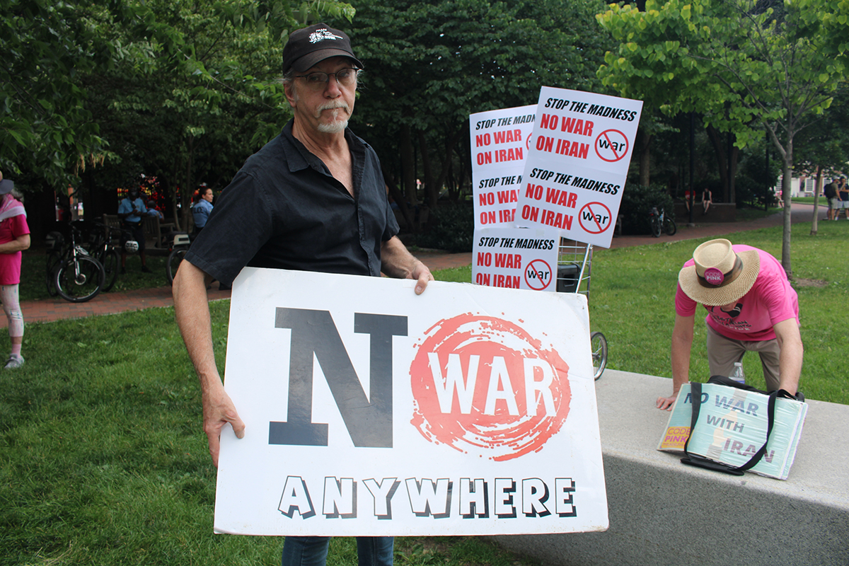 A man holds a sign that reads 