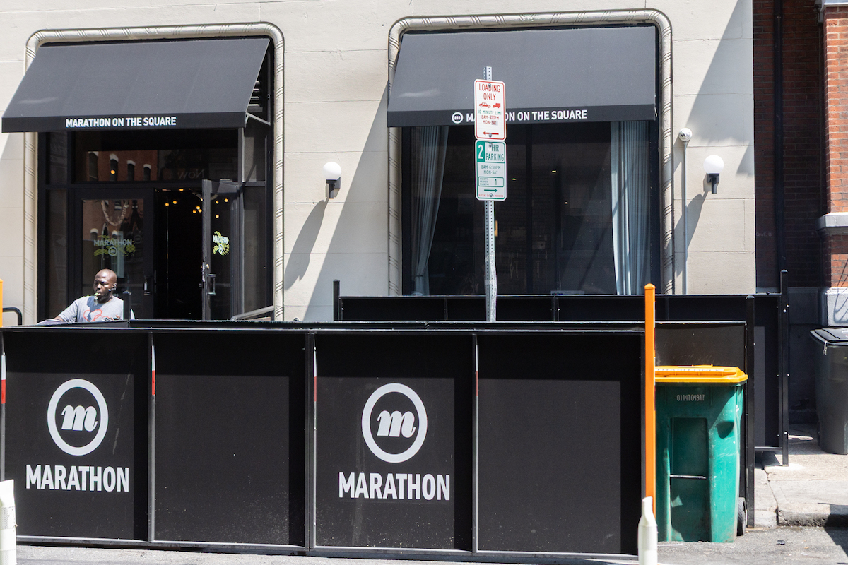 A restaurant’s trash cans block parking on Spruce Street in Center City Philadelphia