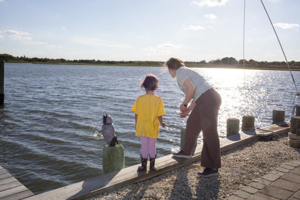 stafford-township-npr-2025-06-13 A mother and daughter skipping rocks into the water