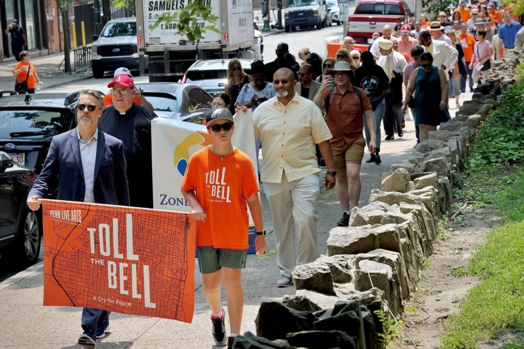 Christopher Gruits leads a march from the Annenberg Center to Philadelphia Episcopal Church