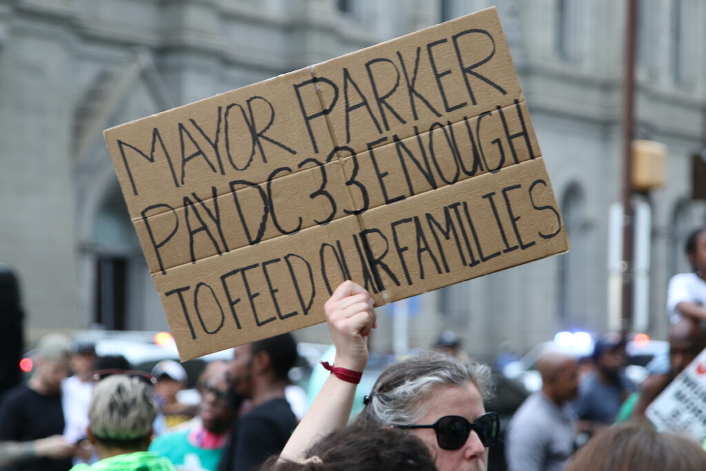 Union members and supporters marched around City Hall