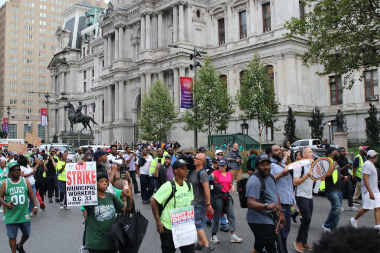 Union members and supporters marched around City Hall