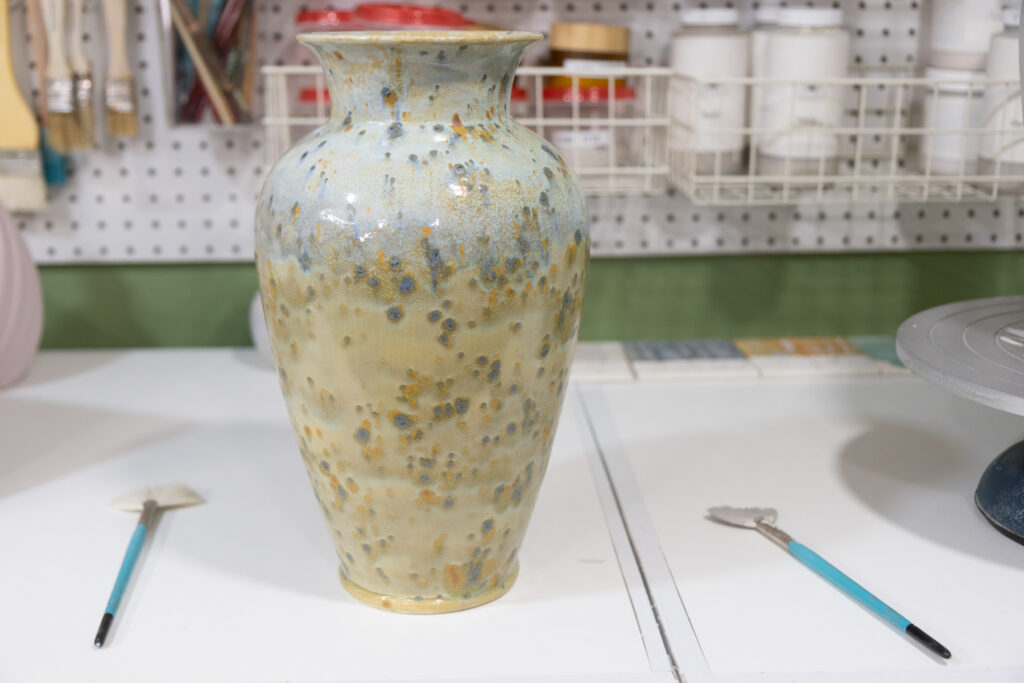 A ceramic vase sits on a table