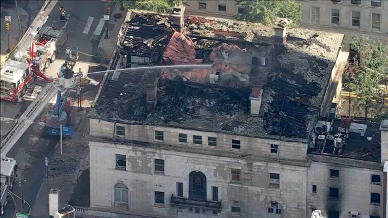 An aerial photo shows a building's roof damaged by a fire