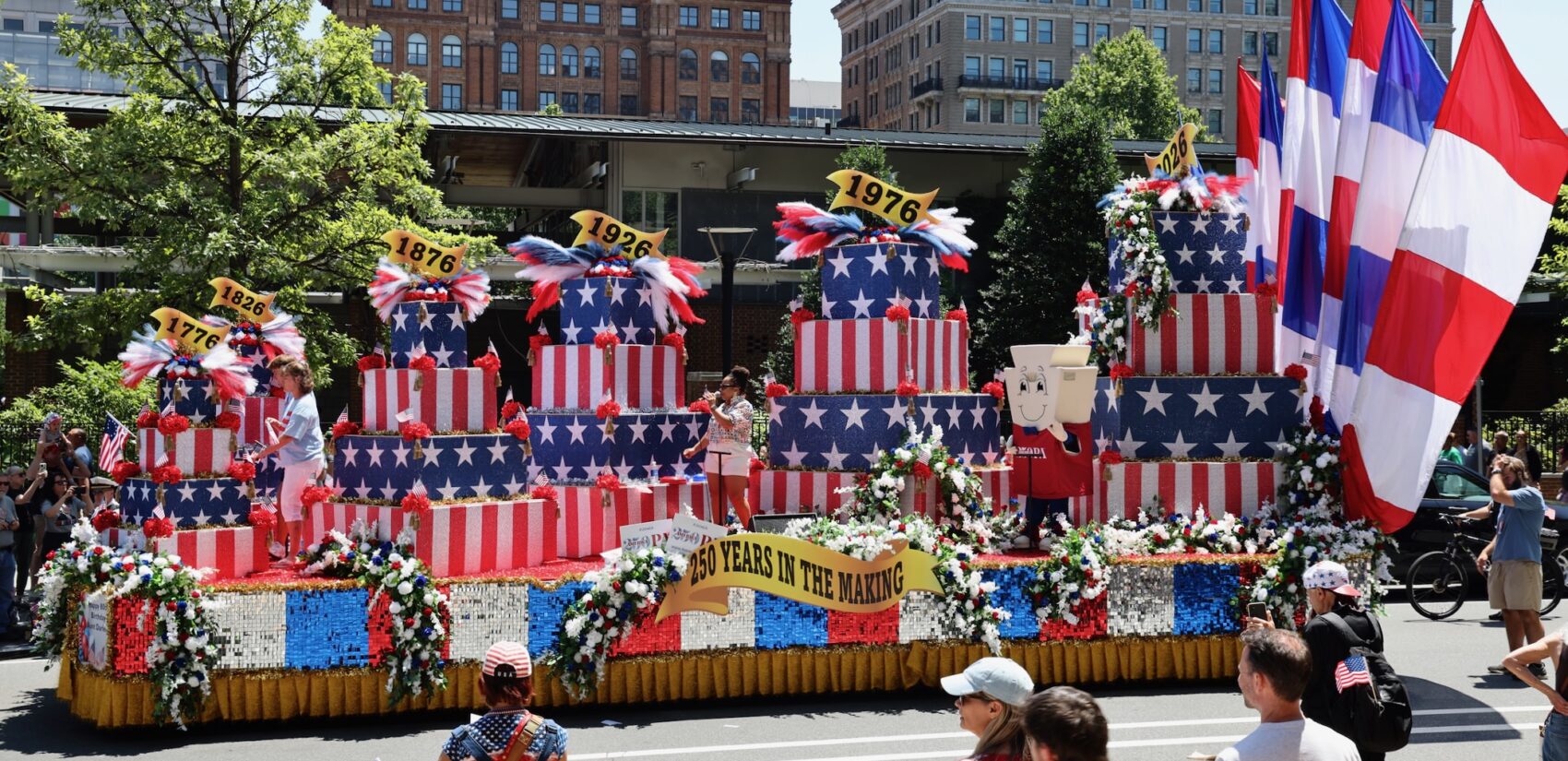 A large float with an American-themed birthday cake drives in downtown Philadelphia during the Fourth of July parade.