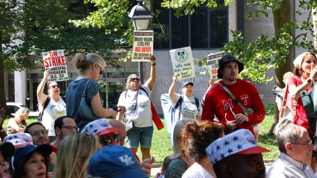 Striking municipal workers chant during Mayor Cherelle Parker's speech at the Celebration of Freedom ceremony at Independence Hall.