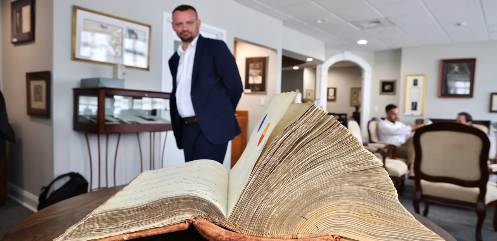 Mayor Viktor Šimunić looks at Joseph Mikulec's autograph book