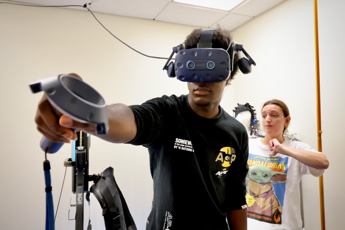 Andrew Otchi using virtual reality device at Drexel University