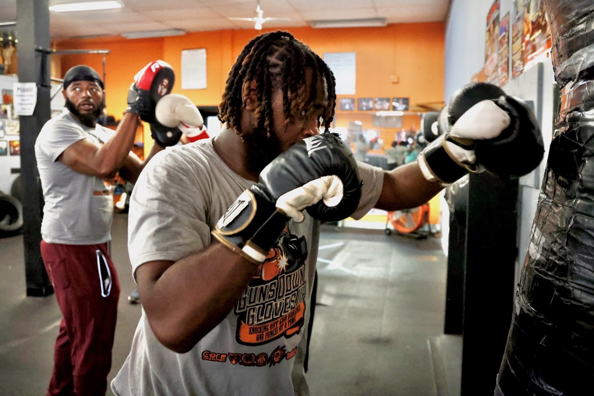 D'Andre Marks hits heavy bag at the Ike Williams Boxing Academy