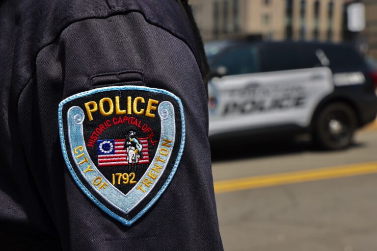 A closeup photo of a Trenton police officer's badge on their arm.