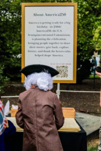 a person in a wig at an America250 event