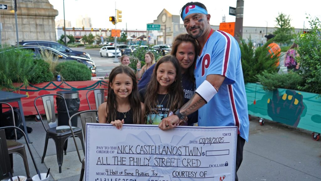 DSC07788-ed-scaled Nick Castellanos look-alike competition winner Michael Penna poses with his wife Nicole and 10-year-old twin daughters, Ariana and Mikayla. (Nick Kariuki/Billy Penn)