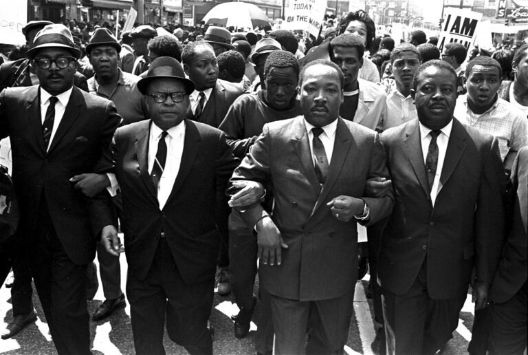 Ralph Abernathy and Bishop Julian Smith flank Dr. Martin Luther King during a civil rights march