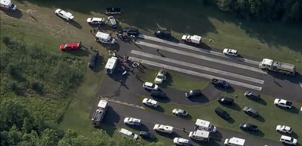 cross_keys_airport_plane_crash_07022025 A large number of vehicles for medical personnel and first responders sit on a runway at an airport following a report of a plane crash