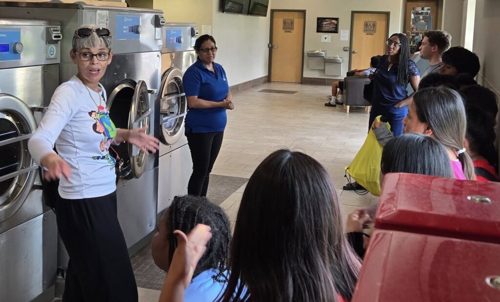 culture-club-pr-delaware-2025 Neyda Albarrán and kids at a Culture Club PR event in a laundromat