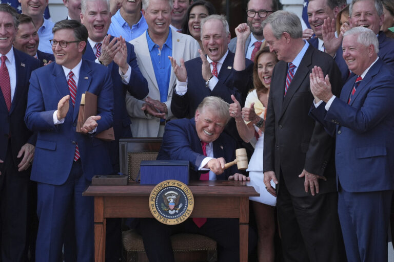 Donald Trump signs his spending bill in front of Republican legislators