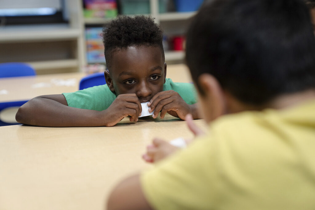 Trump Education Grant Freeze A child sits at a table at school