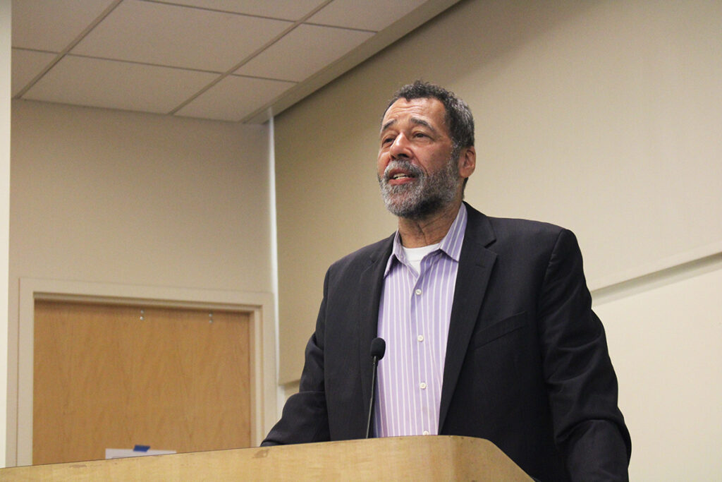 King Downing, lead prosecutor of The People's Tribunal on War Crimes and Genocide in Gaza, stands at a podium
