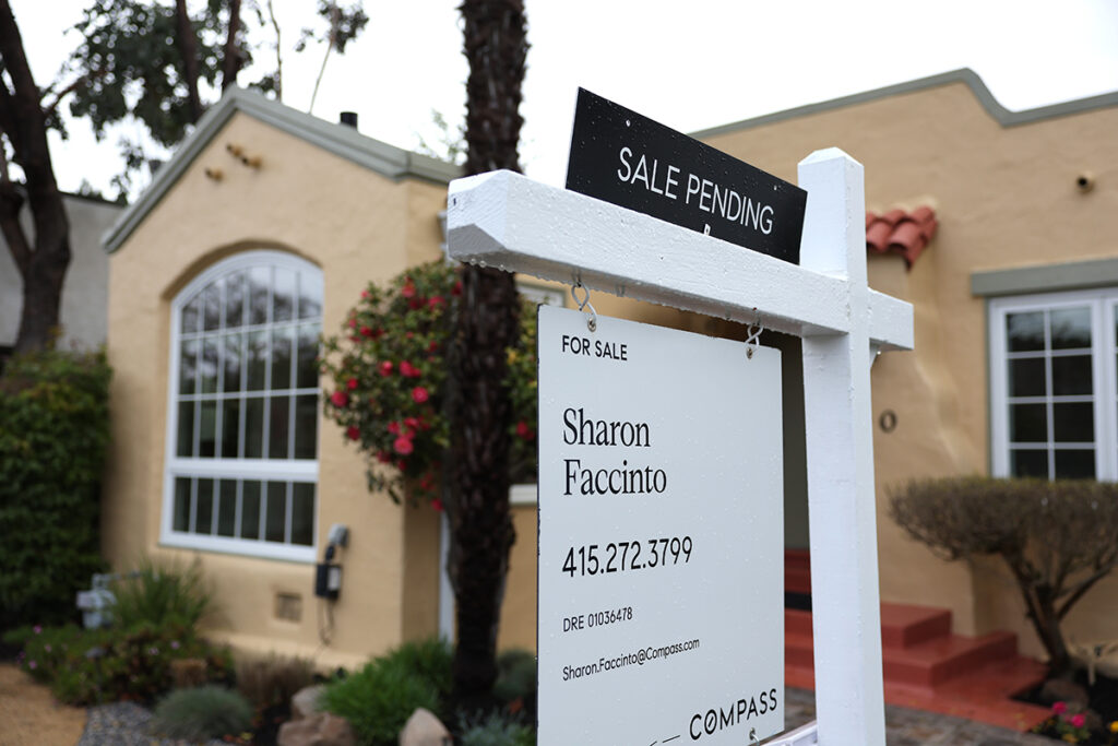 Pre-Existing Home Prices Dropped For First Time In 11 Years In February A for sale sign sits outside of a house