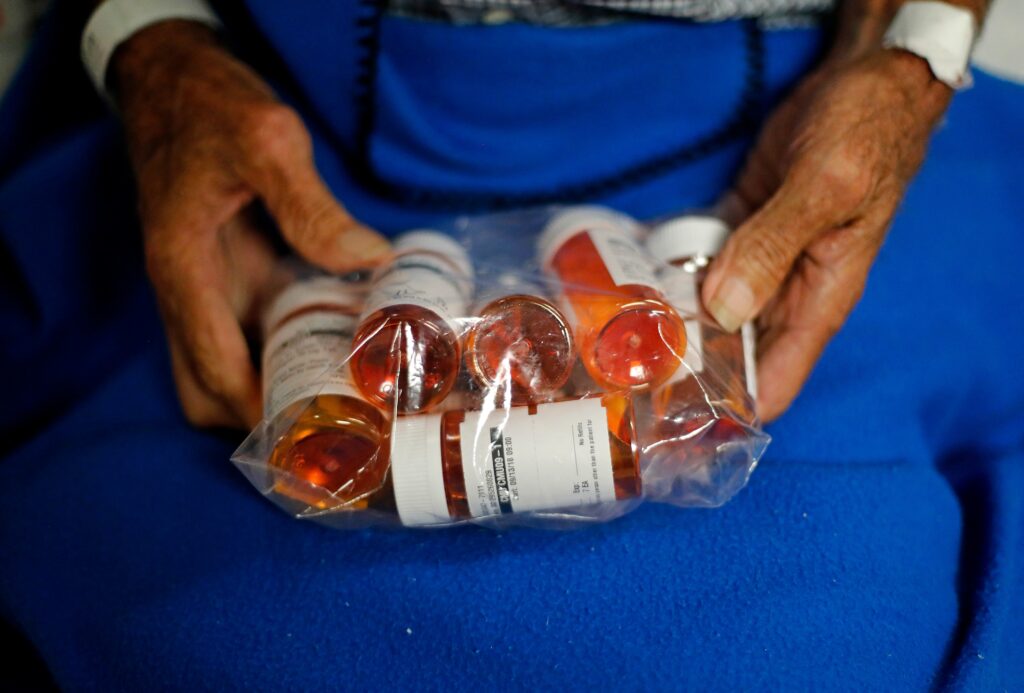 medications-file-AP-heat a bag of medications in someone's hands