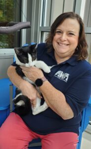 Laura Houston posing for a photo holding a cat