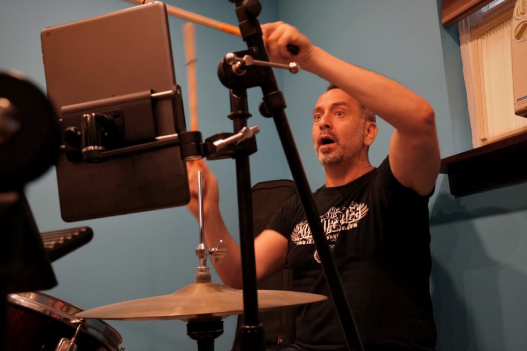 Drummer Ned Sonstein rehearses for an upcoming Live Aid tribute performance