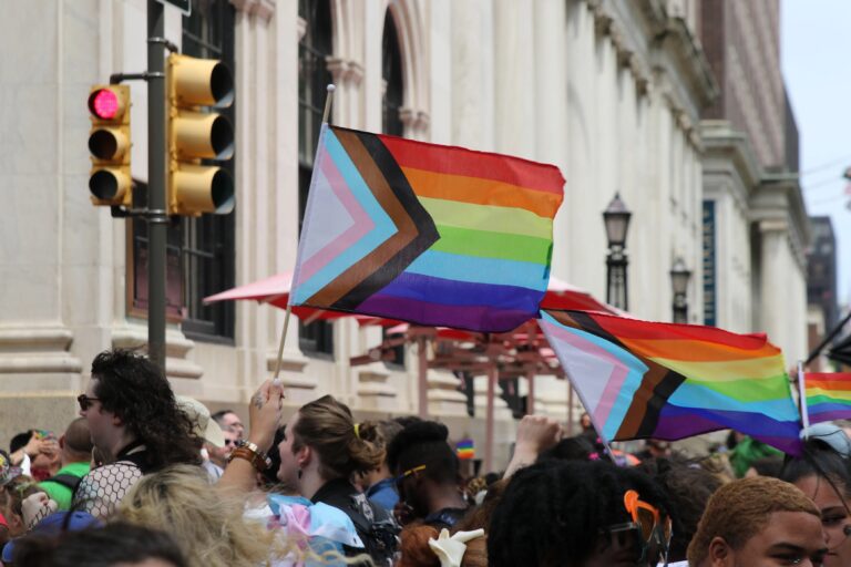 People marching and holding Pride flags