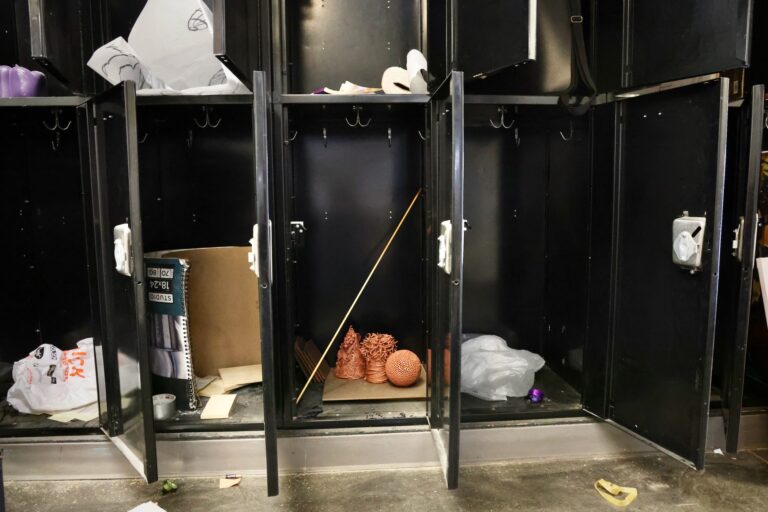 Lockers at Anderson Hall stand open, revealing what students left behind