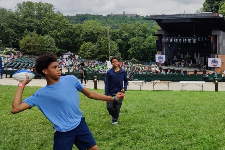 Teenagers throw around a football at Philly Youth Music Fest 2025