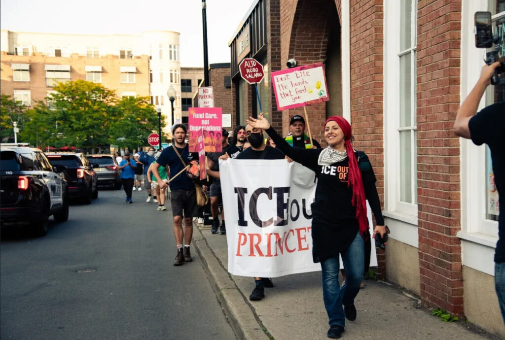 People at a rally holding up signs