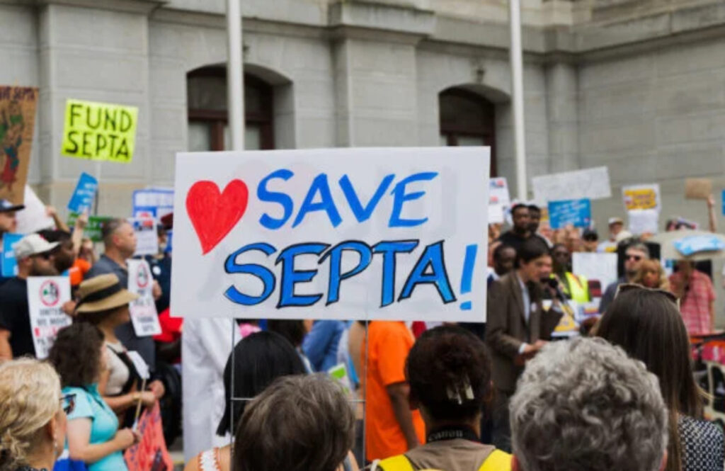 08-06-2025-r-chi-septa-stop-the-cuts-rally-2-768×513-file a sign at a SEPTA rally reads SAVE SEPTA!
