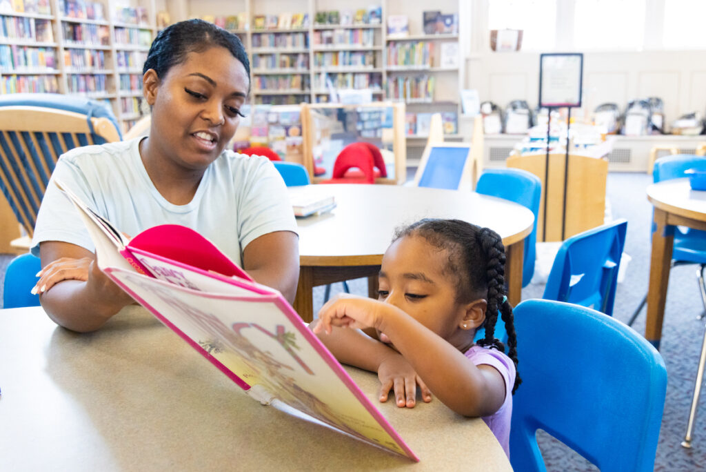 Niya Pugh reading to Zia at Richmond Library