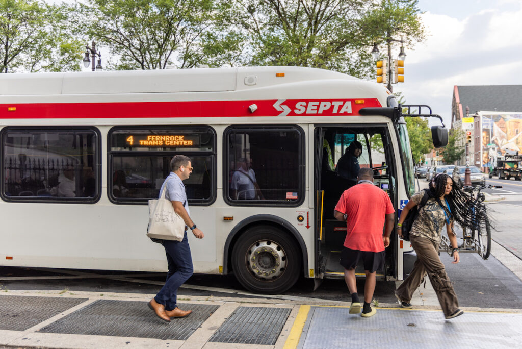 Commuters exit and board the route 4 bus